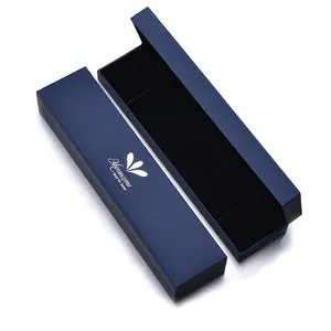 Detail view of a navy blue necklace box with silver logo and black velvet interior lining