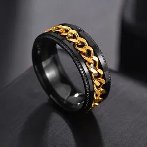 Macro view of men's black stainless steel ring with spinning gold chain inlay