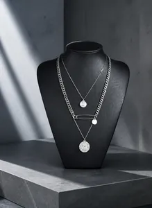 Double-layered silver safety pin necklace with round medallion pendant for a punk style