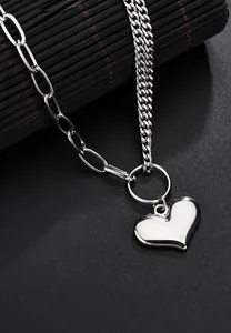 Close-up of stainless steel heart necklace with mixed Cuban and oval link chain