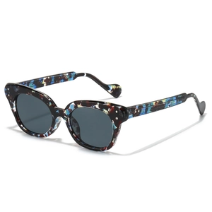 Fashionable cat-eye sunglasses with colorful Bohemian patterns and dark lenses on white base