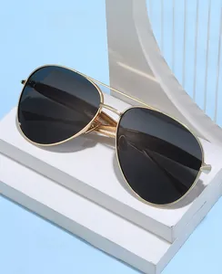 Detailed close-up of golden metal aviator frame with dark lenses on a white pedestal