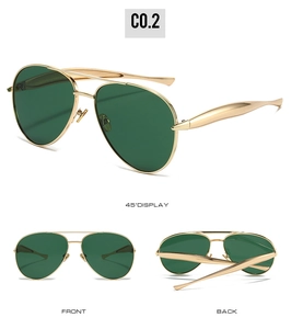 Detail view of gold aviator sunglasses with green lenses and metallic double bridge