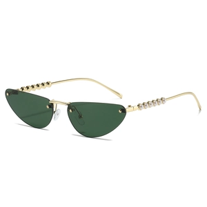 Retro cat-eye sunglasses with green lenses and gold metal temples with pearl detail