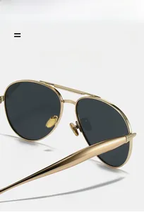 Macro shot of gold metal aviator frame with texture detail and durable hinge construction