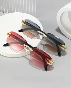 Close-up of rimless square sunglasses with rhinestone-encrusted gold metal hinges