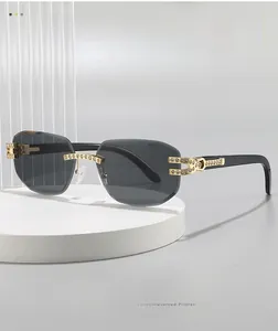Detail of rimless square sunglasses with grey lenses and gold rhinestone-encrusted temples