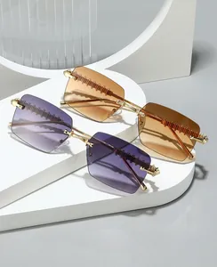Close-up of rimless square sunglasses with metallic serrated texture and gradient lenses