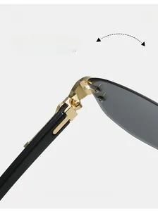Close-up of durable golden metal hinges and gray rimless lenses on these sunglasses