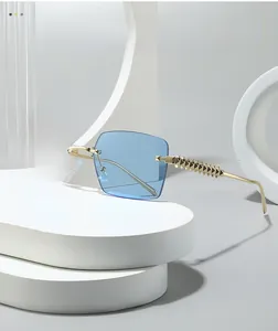 Detail of blue rimless square sunglasses with gold textured spiked metal temples