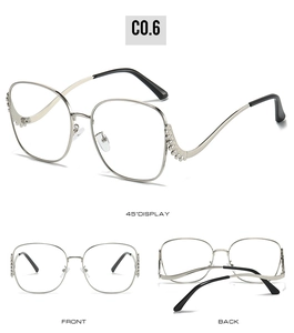 Detailed views showing diamond-encrusted temples and frame of silver metal sunglasses