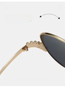 Macro shot of durable golden metal wave hinge on luxury black frame sunglasses