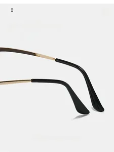 Macro detail of ergonomic curved gold metal sunglasses temples with comfortable black tips