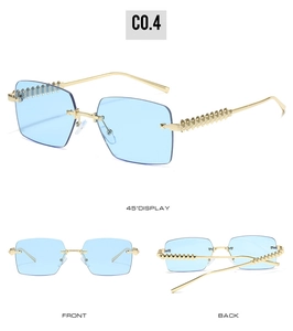 Detail view of rimless square sunglasses with gold studded temples and blue lenses