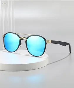 Detail of aviator sunglasses with gold double bridge and blue reflective lenses