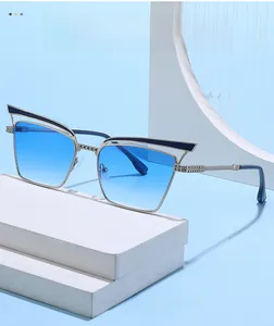Detailed shot of retro cat-eye sunglasses with silver metal frame and blue gradient lenses
