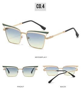 Detail view of retro cat-eye sunglasses with gold metal frame and gradient lenses