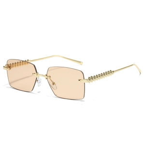 Frameless rectangle sunglasses with gold pyramid studs and champagne tinted lenses