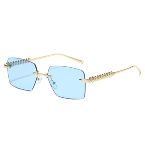 Frameless rimless sunglasses with blue lenses and gold metal studs at 45-degree angle