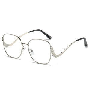 Chic silver metal sunglasses with diamond-encrusted wavy temples and clear lenses