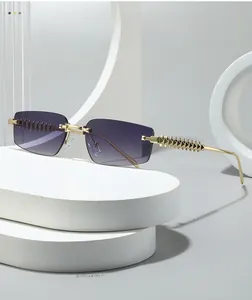 Detail of rimless sunglasses with purple gradient lenses and gold pyramid textured temples