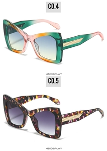 Detail view of large butterfly frame sunglasses with gradient lenses and gold temple accents