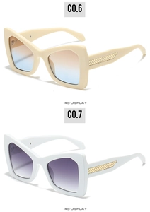 Detail view of oversized cat-eye sunglasses featuring golden woven mesh temple patterns