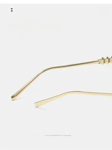 Detail of sleek gold metal temples with curved ends for comfortable glasses wear