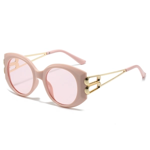 Chic pink oval sunglasses with gold metal temples and hollow B-shaped hinge detail