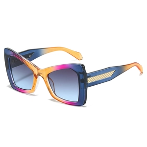 Oversized cat-eye sunglasses with colorful gradient frames and golden textured temples