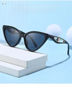 Detail of butterfly frame sunglasses featuring gold metal hollow temples and pearl accents