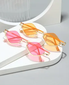 Detail view of pink and orange semi-rimless diamond sunglasses with gold metal frames