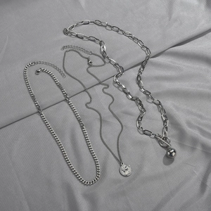Three-piece silver layered necklace set with Cuban chain, coin pendant and OT buckle design