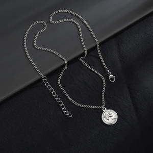 Macro detail of silver coin pendant necklace with lobster clasp and adjustable link chain