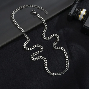Detailed view of silver curb chain necklace with lobster clasp and adjustable link extension