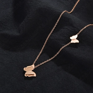 Rose gold stainless steel double butterfly pendant necklace with matte finish details