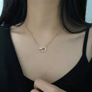 Rose gold titanium double ring necklace with Roman numerals and crystals on a model