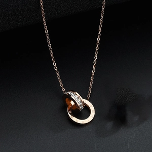Rose gold double ring necklace featuring Roman numerals and sparkling crystals on black