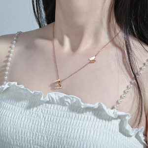 Elegant rose gold double butterfly pendant necklace on a delicate stainless steel chain