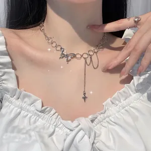 Silver butterfly necklace with cross tassel pendant shown on neck in aesthetic style