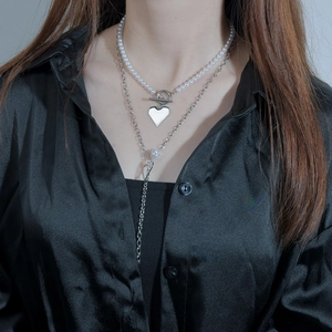 Elegant double-layered pearl necklace with silver heart pendant and OT toggle closure
