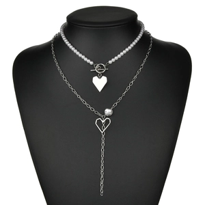 Double-layer silver necklace set with pearls, heart pendant and OT clasp on black bust