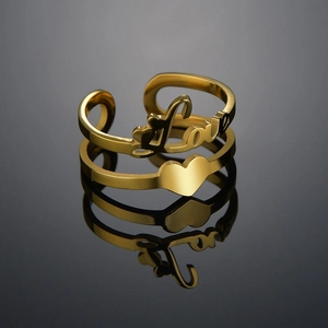 Detailed view of golden double-layered open ring with Love script and heart motif