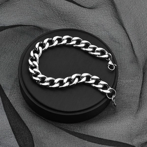 Close-up of polished stainless steel cuban link bracelet with lobster clasp on display