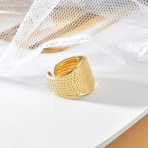 Adjustable gold geometric open ring with textured dot pattern and polished metal finish