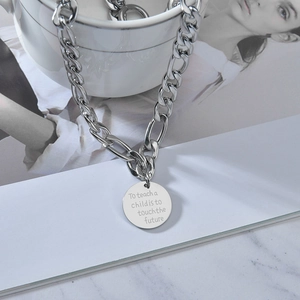 Silver Figaro chain necklace with a round pendant engraved with an inspirational quote