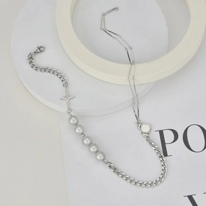 Baroque pearl mixed chain necklace with star pendant on a minimalist white stand