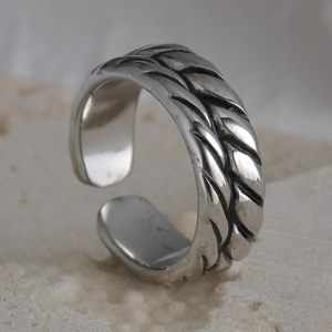 Macro detail of vintage textured silver open ring with braided wheat pattern on stone