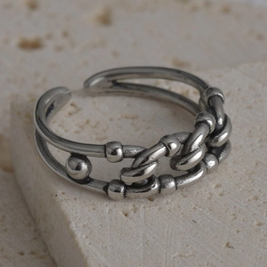 Detailed macro shot of vintage silver chain-link style adjustable ring on stone base