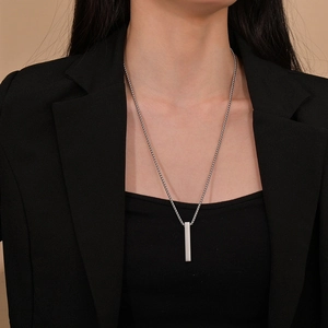 Minimalist silver vertical bar pendant necklace with pearl bead chain on a female model